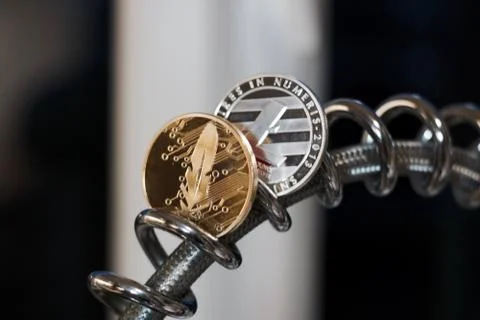 Cryptocurrency feather coin Stock Photos