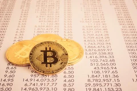 Cryptocurrency, Gold bitcoins on transfer statement. Stock Photos