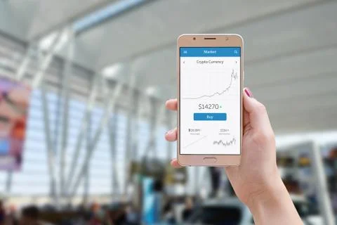 Cryptocurrency graph value on smart phone app. Woman holding phone. Business, Stock Photos