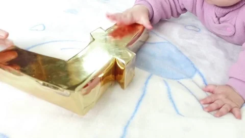 Cryptocurrency in the hands of an infant. Video. Playing with Litecoin Stock Footage 83771625