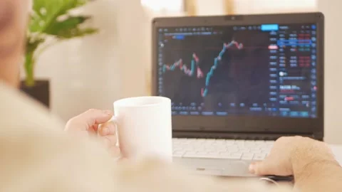 Cryptocurrency market, chart on laptop screen, man working at home. Checks news Stock Footage 167944547