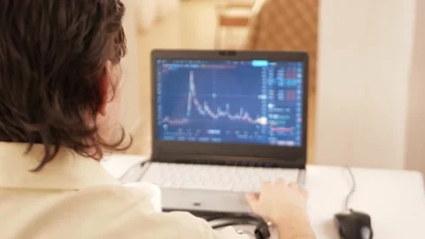 Cryptocurrency market, chart on laptop screen, man working at home. Checks news Video stock 167944555