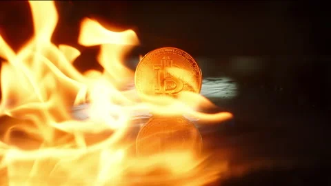 Cryptocurrency market fall concept. Bitcoin gold coin is on fire Stock Footage 168771956