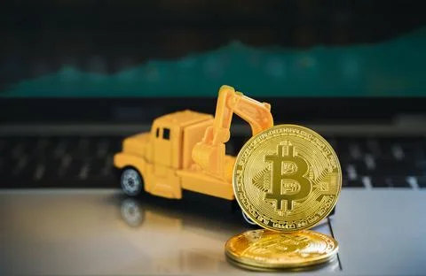 Cryptocurrency mining concept, Bitcoin is placed in front of the excavator ov Foto stock