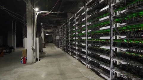Cryptocurrency mining equipment on large farm. ASICs on stand racks mine bitcoin Video stock 126409505