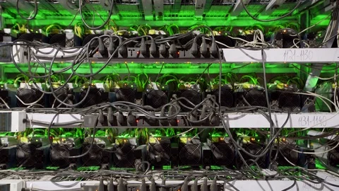 Cryptocurrency mining equipment on large farm. ASIC miners on stand racks mine Stockbeeldmateriaal 126409881