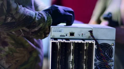 Cryptocurrency mining farm for Bitcoin and altcoins. Cryptocurrency miner repair Stock Footage 321392198