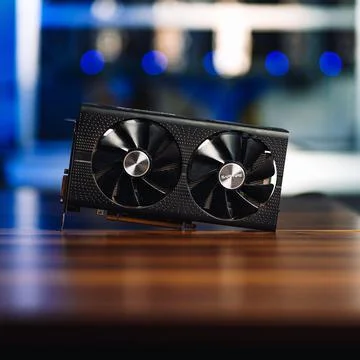 Cryptocurrency mining GPU rig computer graphics card on the table, close-up Stock Photos