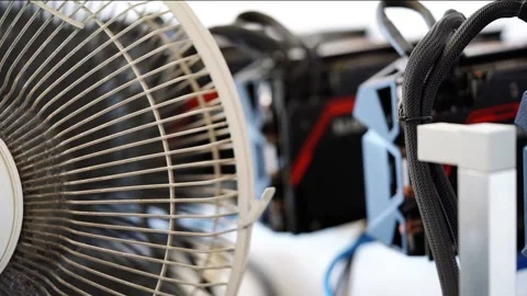 Cryptocurrency mining rig being cooled by old dusty fan, blurred video graphi Stock Footage 131967945