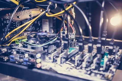 Cryptocurrency mining rig PCIe riser extenders plugged to motherboard. Stock-Fotos