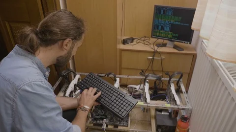 Cryptocurrency specialist encrypting system information typing code and data  Stock Footage 102475100