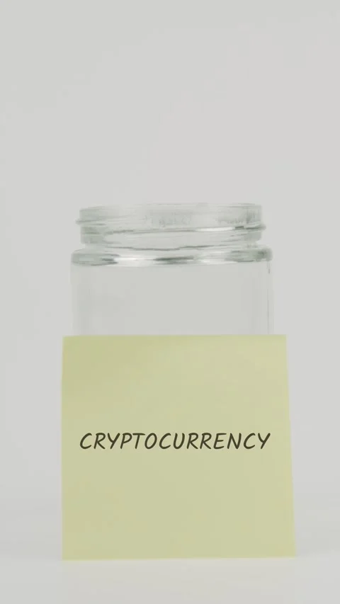 Cryptocurrency Text or word on yellow sticky note attached to glass jar Stock Footage 311705793