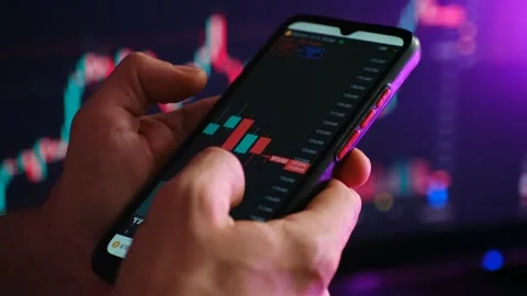 Cryptocurrency trader analyzing bitcoin price chart on smartphone Stock Footage 318947022