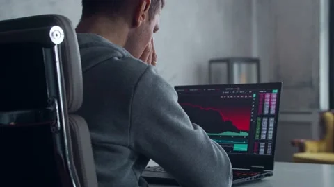 Cryptocurrency Trader at his Workplace in front of a Computer. Laptop Monitor Stock Footage 195083889