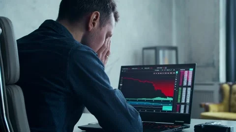Cryptocurrency Trader at his Workplace in front of a Computer. Man Commits Stock-Footage 195199329