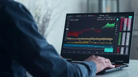 Cryptocurrency Trader at his Workplace in front of a Computer. Laptop Monitor Stock Footage 195199494