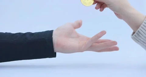 Crypto's, cryptocoins, Bitcoin or BTC,being dropped in a man's hand, depicting Stock Footage 166241367