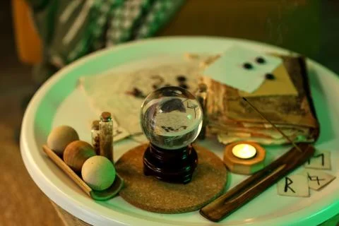 Crystal ball and magic attributes on table Stock Photos