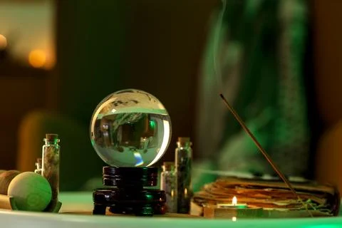 Crystal ball and magic attributes on table Stock Photos