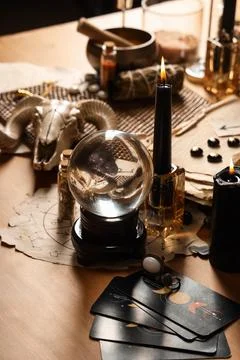 Crystal ball and magic attributes on table Stock Photos