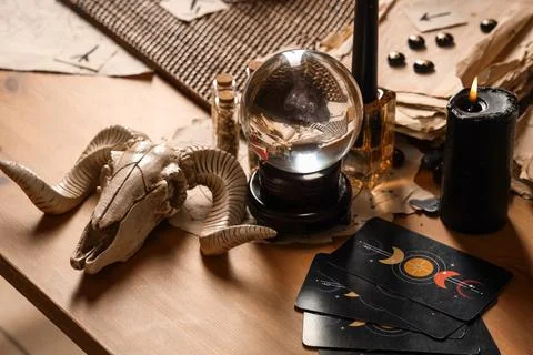 Crystal ball and magic attributes on table Stock Photos