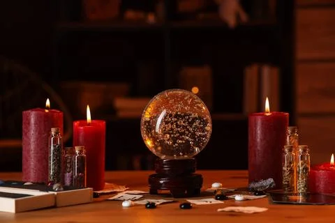 Crystal ball and magic attributes on table Stock Photos