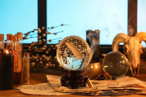 Crystal ball and magic attributes on table Stock Photos