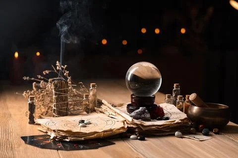 Crystal ball and magic attributes on table Stock Photos