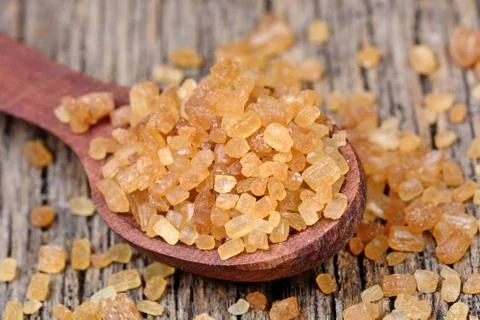 Crystal beige sugar in a spoon 스톡 사진