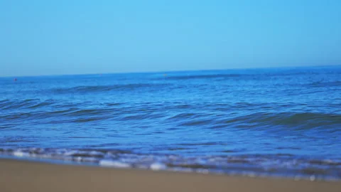Crystal blue ocean waves rolling onto the shore on a sunny summer day, calming Stock Footage 335298491