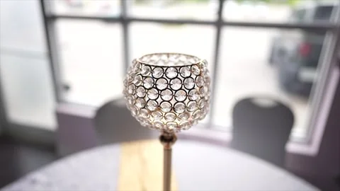Crystal candle holder on a table in front of a window Stock Footage 266439410