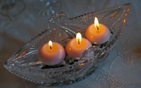 Crystal capacitance with three burning candles Stock Photos