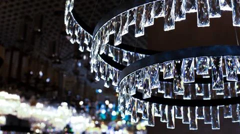 Crystal chandelier with rectangular glass plates, cold blue light backdrop... 스톡 사진
