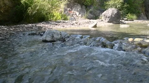 Crystal clean mountain stream flowing in nature. Rocky stream Stock Footage 139923575