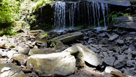 Crystal clean small waterfall close up shot in Transylvania Stock Footage 115394701