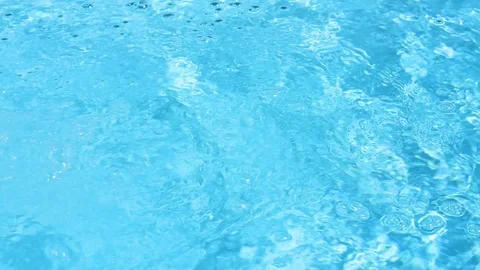 Crystal clear, blue and sparkling water in a paddling pool in the sunshine an Stock Footage 93649813