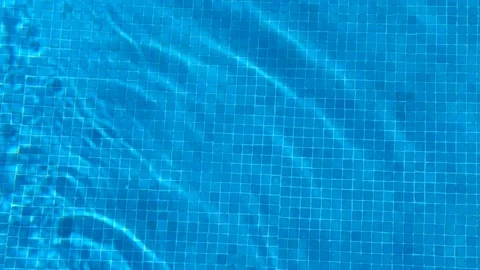 Crystal clear blue pool water with a cube pattern at the bottom of the pool at a Stock Footage 201110983
