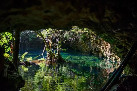 Crystal clear cenote pool inside limestone cave Stock Photos