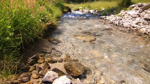 Crystal clear clean mountain stream flowing through the alps of Austria Stock Footage 158612375