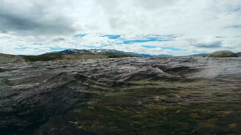 Crystal clear drinking water in the mountain river stream running. Cold river Stock Footage 110419959