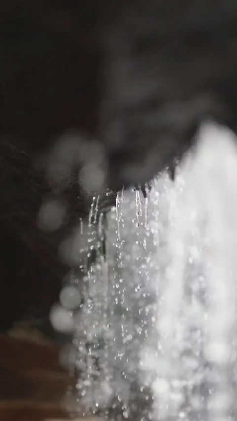 Crystal-clear droplets drip from rocks in slow motion, each drop shining. I.. Stock Footage 292563896