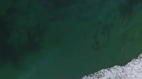Crystal Clear Flyover of Rolling Waves Crashing at Sunset in Crystal Cove Stock Footage 157190829