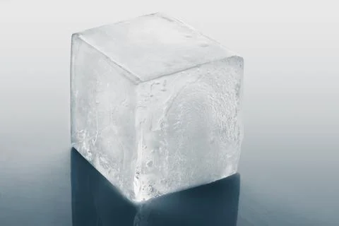 Crystal clear ice cube on light grey background Stock Photos
