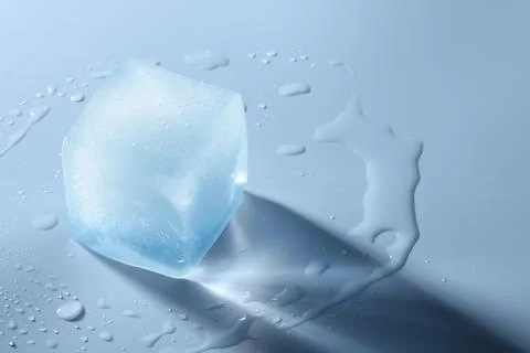 Crystal clear ice cube on light blue background, space for text Foto stock