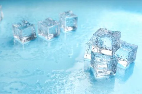 Crystal clear ice cubes on light blue background. Space for text Stock Photos