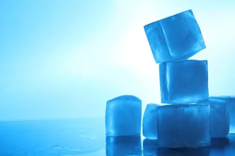 Crystal clear ice cubes on light blue background, space for text. Color ton.. Stockfoto's