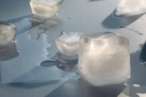 Crystal clear ice cubes on light grey background Stock Photos