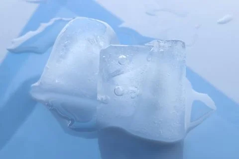 Crystal clear ice cubes on light blue background, closeup Foto stock