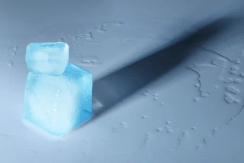 Crystal clear ice cubes on light blue background, space for text Stockfoto's