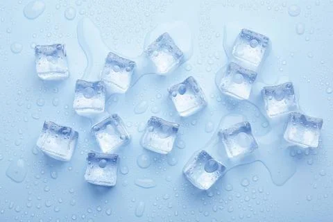 Crystal clear ice cubes on light blue background, flat lay Stock Photos